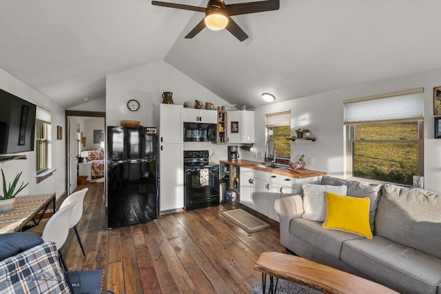 living room with vaulted ceiling, ceiling fan, dark hardwood / wood-style floors, and sink