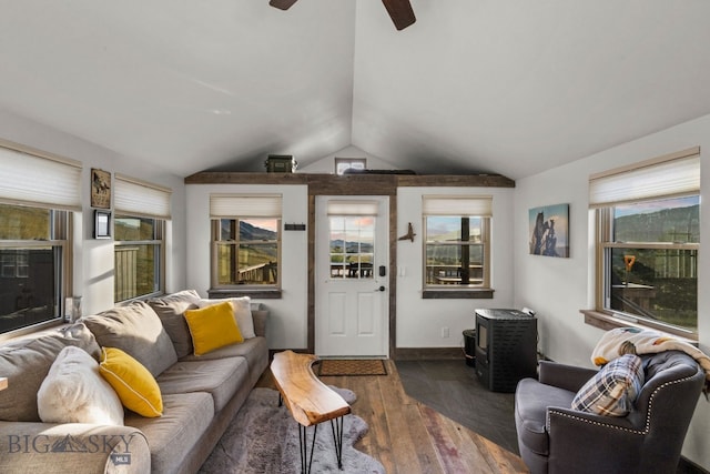 living room featuring ceiling fan, lofted ceiling, dark hardwood / wood-style flooring, and a healthy amount of sunlight