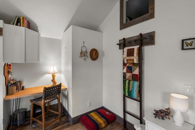 home office featuring vaulted ceiling and dark hardwood / wood-style flooring