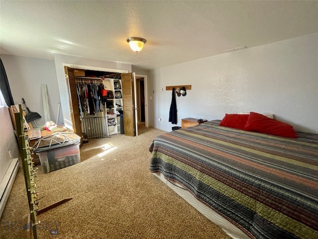 bedroom featuring a textured ceiling, a closet, baseboard heating, and carpet flooring