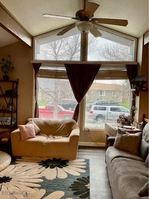 sunroom / solarium with ceiling fan, lofted ceiling, and a healthy amount of sunlight