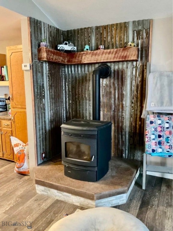 room details featuring wood-type flooring and a wood stove