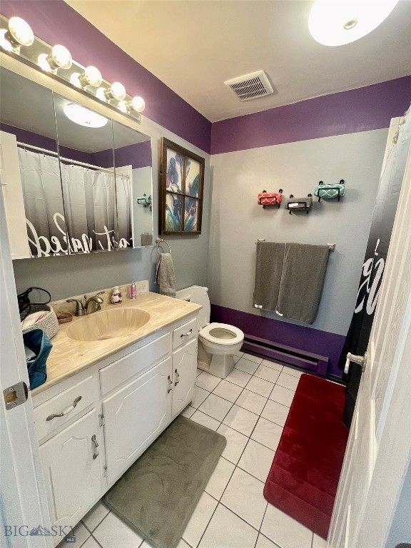 bathroom with vanity, a baseboard radiator, toilet, and tile patterned floors