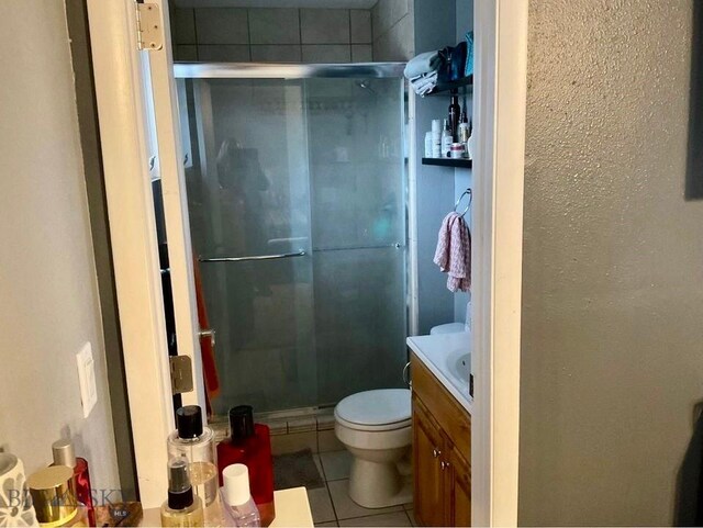 1115 E Center St, Dillon, MT 59725 - bathroom featuring vanity, tile patterned flooring, toilet, and a stall shower