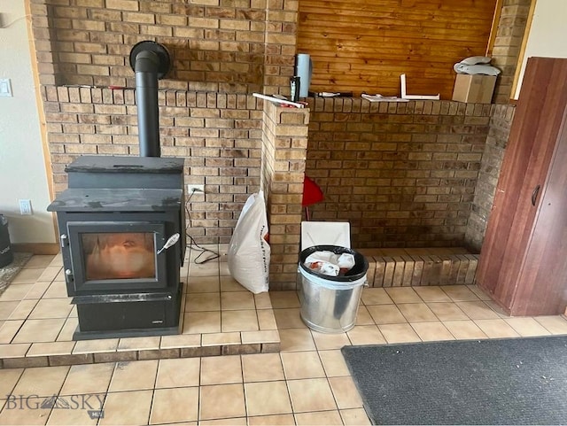 interior details featuring a wood stove and tile patterned floors