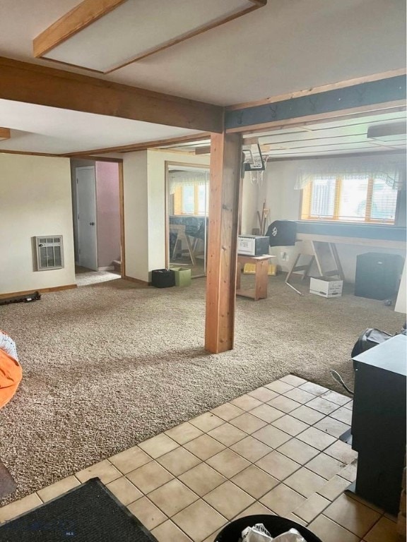 basement with heating unit, plenty of natural light, and carpet flooring