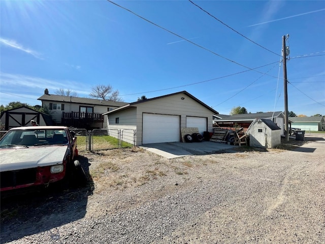 view of front of home featuring a storage shed and a garage