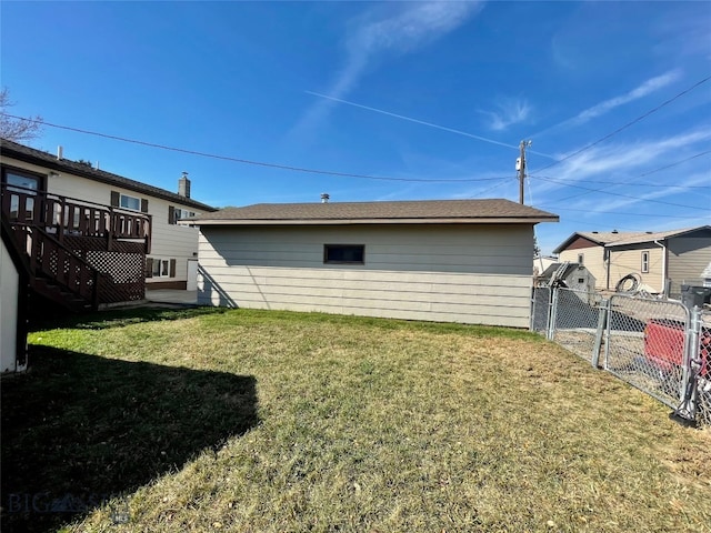 back of house with a yard and a deck