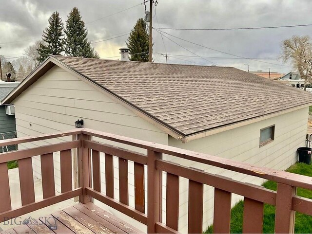 1115 E Center St, Dillon, MT 59725 - view of side of home with a shingled roof and a wall unit AC