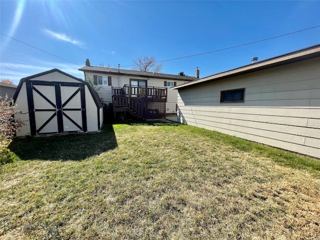 view of yard featuring a storage unit and a wooden deck