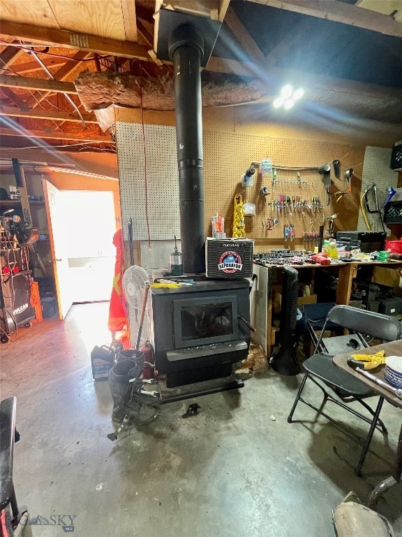 basement featuring a workshop area and a wood stove