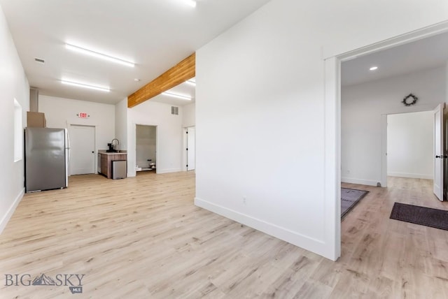 500 Stubbs Ln, Bozeman, MT 59718 - kitchen featuring freestanding refrigerator, light wood-style floors, beam ceiling, and open floor plan