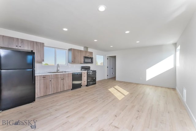 500 Stubbs Ln, Bozeman, MT 59718 - kitchen with black appliances, light countertops, light wood-type flooring, and recessed lighting
