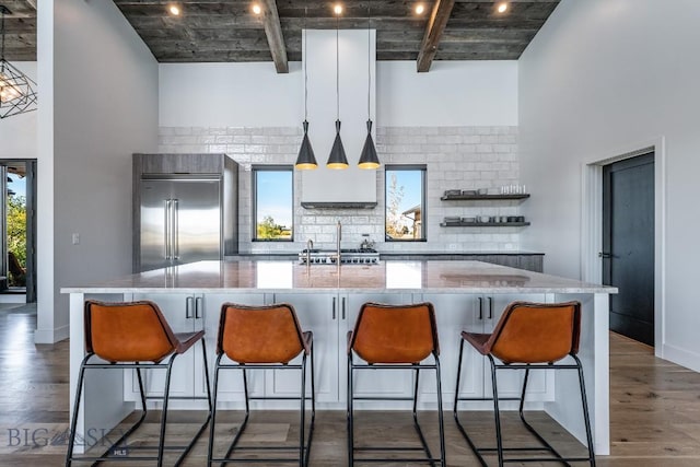 500 Stubbs Ln, Bozeman, MT 59718 - kitchen with stainless steel built in refrigerator, wood finished floors, decorative backsplash, a spacious island, and a high ceiling
