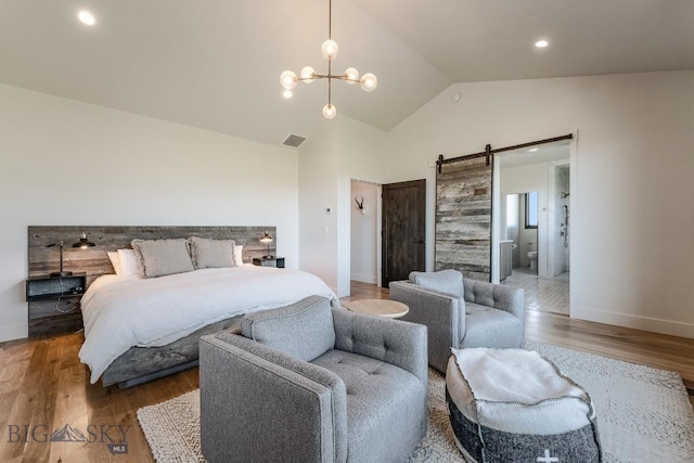 500 Stubbs Ln, Bozeman, MT 59718 - bedroom featuring a barn door, wood finished floors, a chandelier, high vaulted ceiling, and recessed lighting
