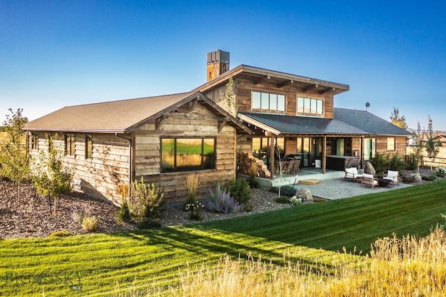 500 Stubbs Ln, Bozeman, MT 59718 - back of house with a patio area, a chimney, a yard, and a metal roof