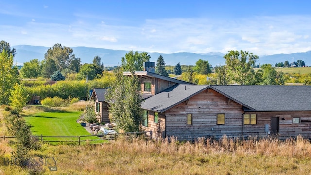 view of property exterior featuring a yard and a mountain view