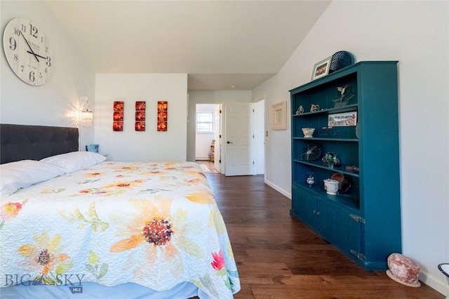 bedroom with lofted ceiling and dark hardwood / wood-style floors