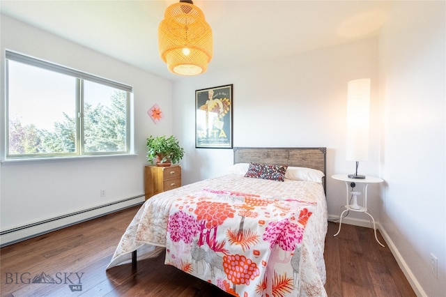 bedroom with baseboard heating and dark hardwood / wood-style floors