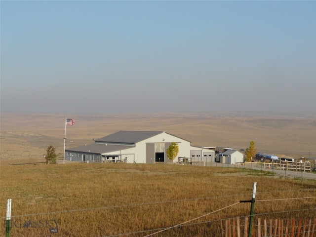 yard at dusk with a rural view