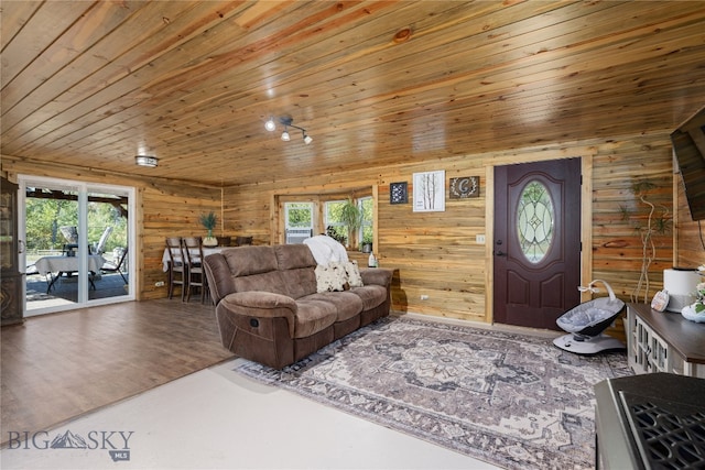 living room featuring wood-type flooring, wooden ceiling, and a wealth of natural light