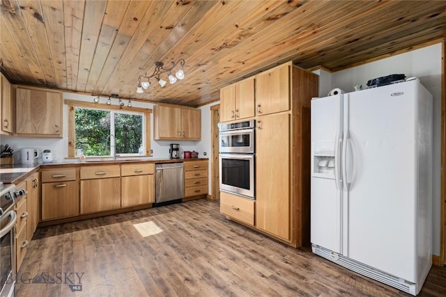 kitchen featuring wood ceiling, a sink, appliances with stainless steel finishes, light brown cabinets, and wood finished floors