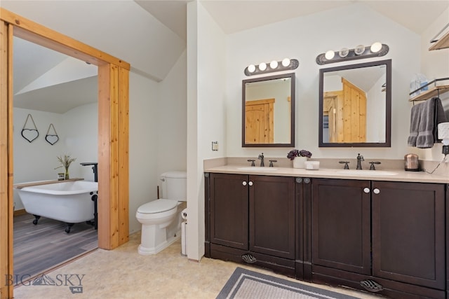 bathroom with vanity, lofted ceiling, hardwood / wood-style flooring, a tub to relax in, and toilet