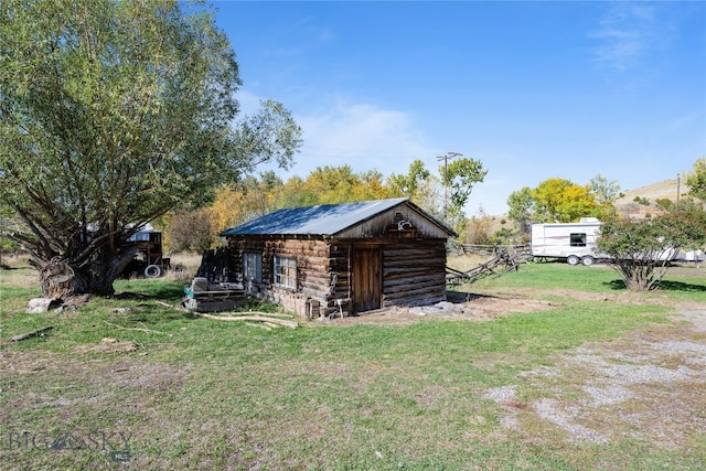 view of outbuilding with a yard