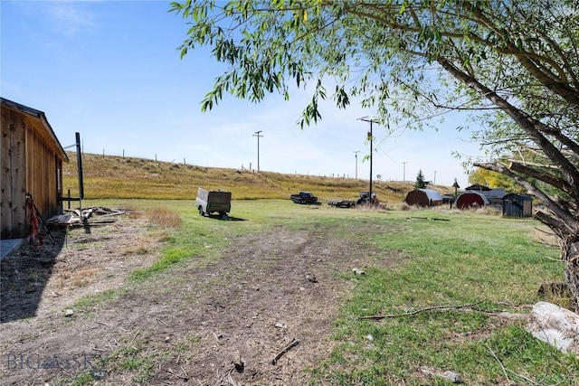 view of yard with a rural view
