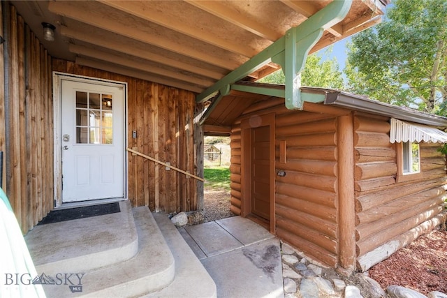 view of exterior entry with log exterior