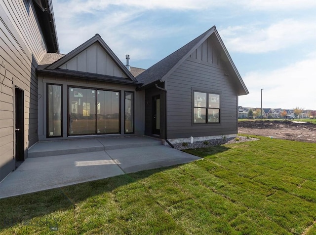 rear view of house with a yard and a patio area