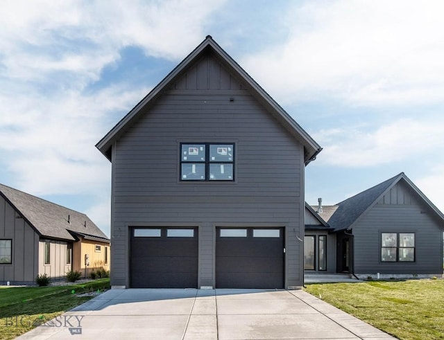 modern inspired farmhouse featuring a garage and a front yard