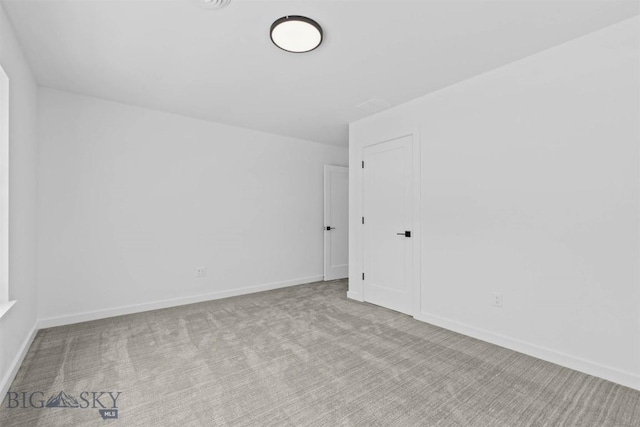 unfurnished room with light colored carpet