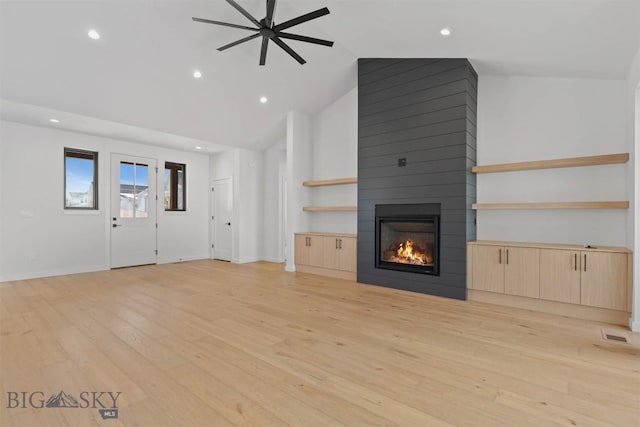 unfurnished living room with ceiling fan, light hardwood / wood-style floors, a fireplace, and high vaulted ceiling