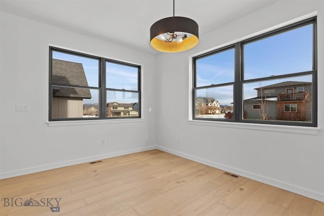 spare room with hardwood / wood-style flooring