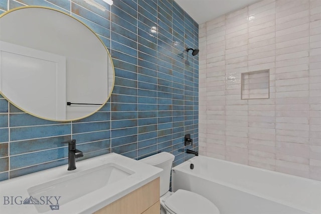 full bathroom with vanity, tiled shower / bath combo, decorative backsplash, toilet, and tile walls