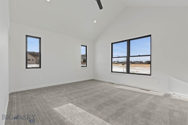 unfurnished room featuring carpet floors, ceiling fan, plenty of natural light, and high vaulted ceiling