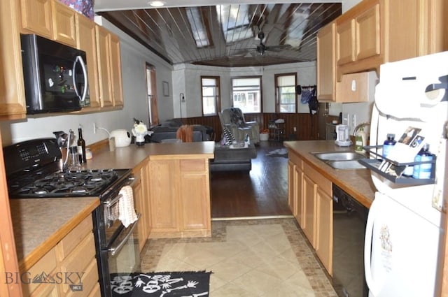 kitchen featuring wooden ceiling, light hardwood / wood-style flooring, vaulted ceiling, sink, and black appliances