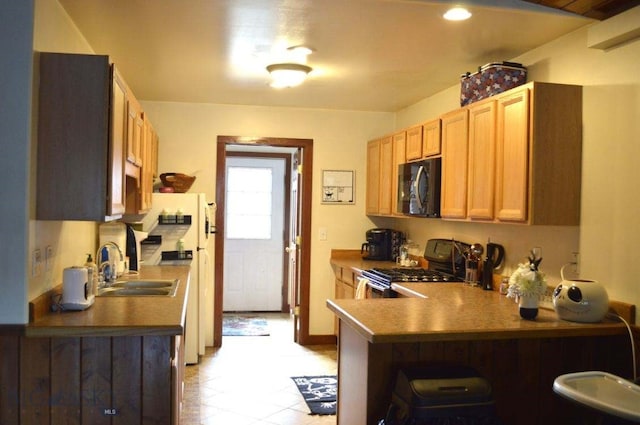 kitchen featuring kitchen peninsula and black appliances