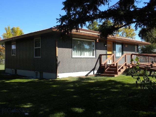 rear view of property featuring a yard