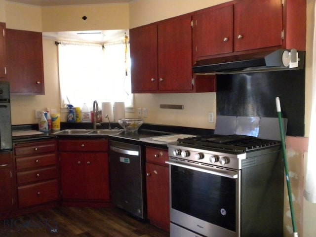 kitchen with appliances with stainless steel finishes, sink, and dark hardwood / wood-style flooring