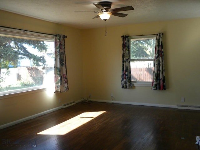 empty room with ceiling fan, a baseboard radiator, and dark wood-type flooring