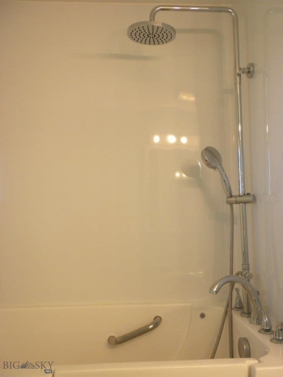 interior details with shower with separate bathtub