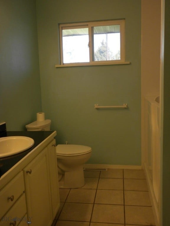 bathroom featuring tile patterned floors, vanity, and toilet