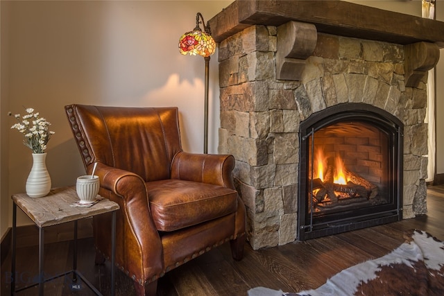 sitting room featuring a fireplace and dark wood-type flooring