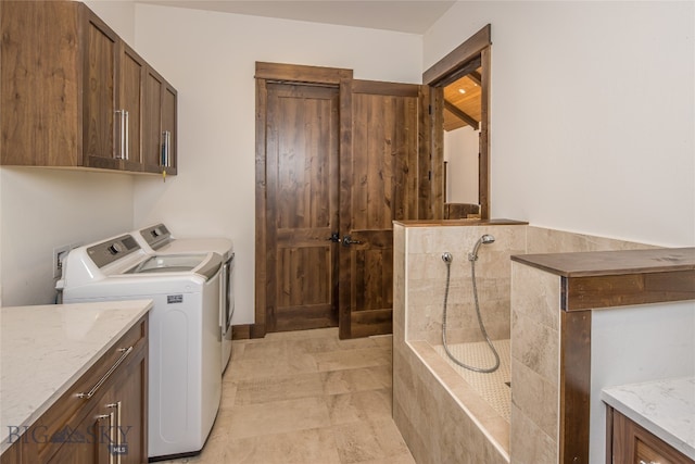 washroom featuring cabinets and washer and dryer