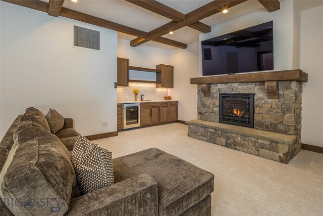 2250 Outlook Trl, Big Sky, MT 59716 - living room featuring beverage cooler, beam ceiling, light colored carpet, coffered ceiling, and a stone fireplace
