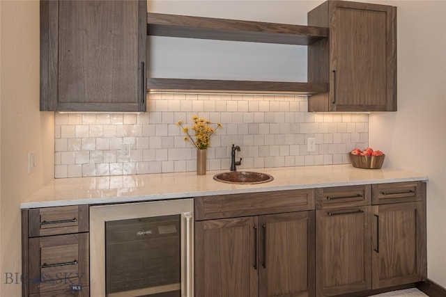 2250 Outlook Trl, Big Sky, MT 59716 - kitchen featuring wine cooler, tasteful backsplash, light stone countertops, and open shelves