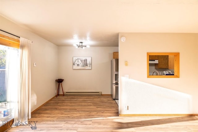 hall featuring a baseboard radiator and hardwood / wood-style flooring