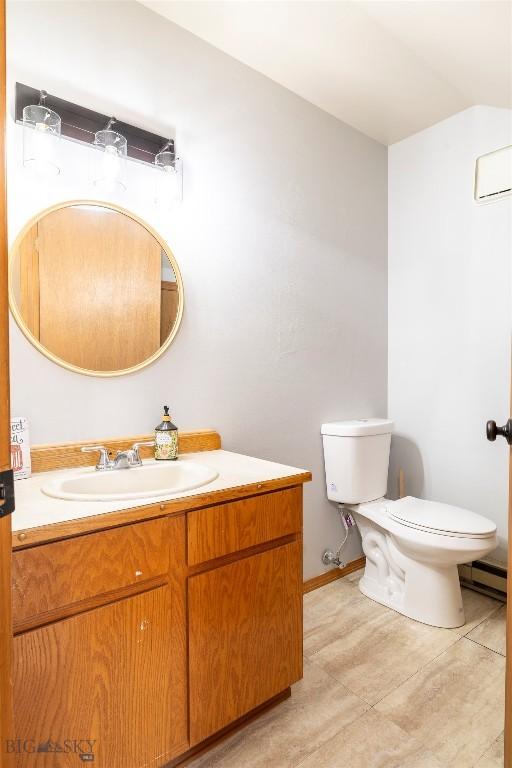 bathroom featuring vanity, toilet, and a wall mounted AC